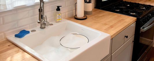 Enameled Cast Iron Dutch Oven in soapy sink