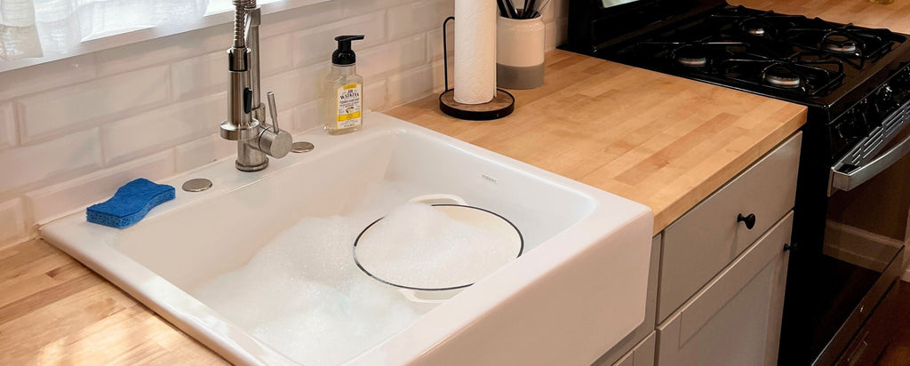 Enameled Cast Iron Dutch Oven in soapy sink