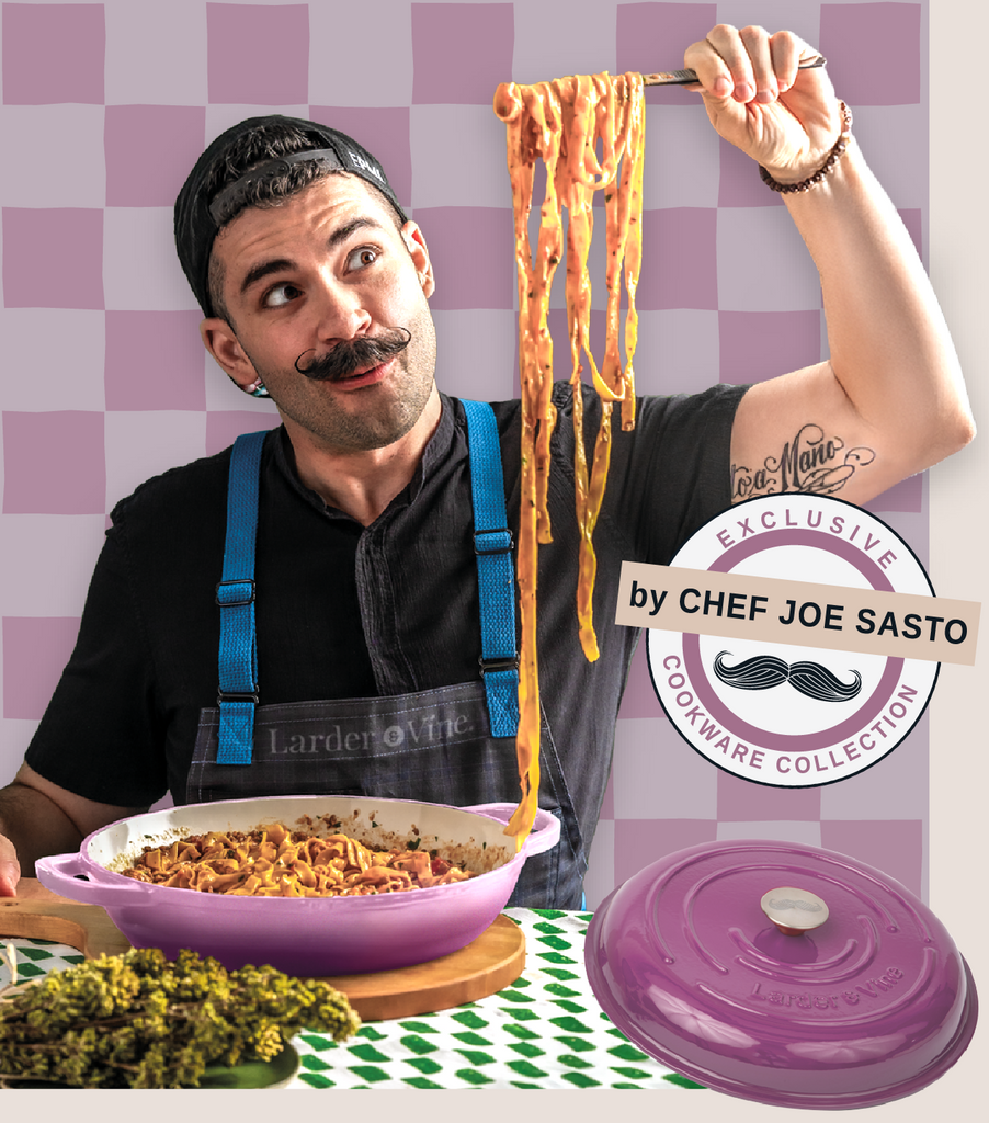 Chef Joe Sasto holding up pasta with Larder & Vine cookware set on a checkered background