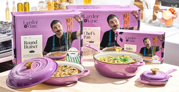 Larder & Vine purple enameled cast iron cookware set with branding and images of a chef Joe Sasto on packaging