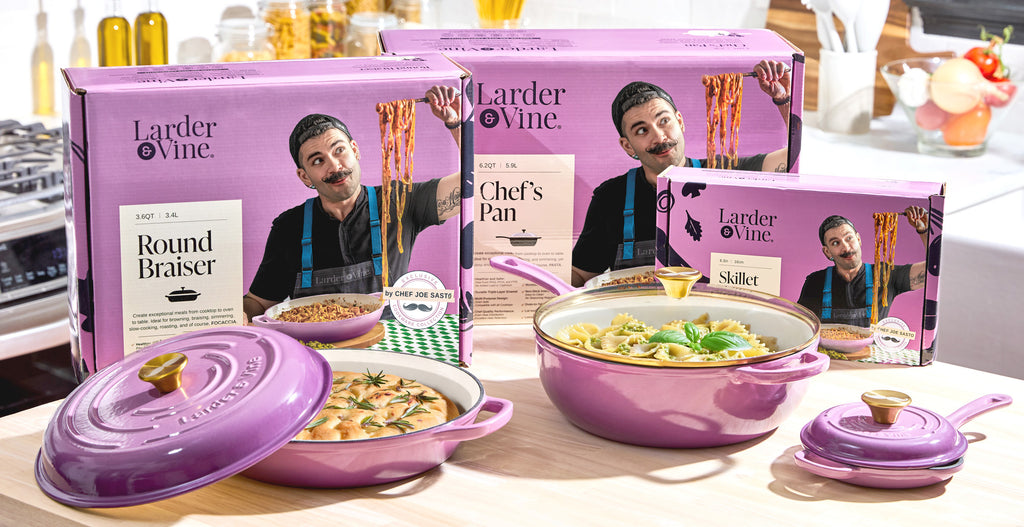 Larder & Vine purple enameled cast iron cookware set with branding and images of a chef Joe Sasto on packaging